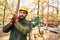 Two forest workers carry a tree trunk