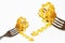 Two fork with swirl pasta fusilli col buco on white background