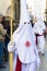 Two fraternity members during Palm Sunday procession