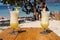 Two fresh alcohol cocktail on the beach. Cold pina colada on seascape background. Pair of cool pineapple cocktails with straw.