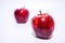 Two fresh bright red apples