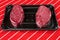 Two fresh fillet steaks on a plastic tray on a red and white butcher apron. Meat and retail industry concept. Premium cut of beef