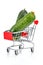 Two fresh green cucumbers in the chromed toy market shopping cart with red handle and plastic board on the front with reflection