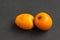 Two fresh loquats medlars on a dark background, close-up. Horizontal orientation, copy space