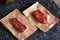 Two fresh, organic juicy striploin steaks on food paper. Premium quality meat steaks. Raw materials for grilling and barbecue.
