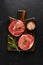 Two fresh Parisienne raw steak on wooden Board with salt, pepper and rosmary in a rustic style on old wooden background. Black