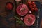 Two fresh Parisienne raw steak on wooden Board with salt, pepper and rosmary in a rustic style on old wooden background. Black