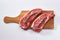 Two fresh raw striploin steak on wooden board on white background with rosmary top view