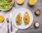 Two fried chicken breasts with curry, fresh orange juice, fresh salad nutrition athletes wooden rustic background top view