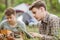 Two friend sitting in the tent, playing guitar and reading