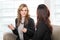 Two friendly businesswomen sitting