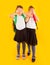 Two friendly schoolgirls in uniform holding hands on eyes