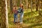 Two friendly women hiking together, go forward in the forest