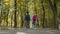 Two Friends With Backpacks Are Going to School. Back View of Mixed Racial Group of School Kids Walking in the Park. Slow