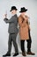 Two friends dressed in vintage clothes and depict retro detectives and spies in English classic style on a white studio background