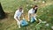 Two friends, eco activists wearing uniform and rubber gloves with trash bag in hands cleaning forest or park from