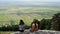 Two friends girlfriends,sisters talking on the high lookout, plain in the background