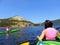 Two friends in kayaks talking and exploring the beautiful waters in Bonne Bay, Gros Morne National Park