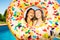 Two friends laughing inside inflatable doughnut