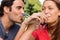 Two friends link their arms together while drinking champagne