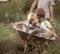 Two friends playing in the plane using a garden carts