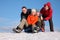 Two friends push two of others on sleighs