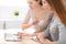 Two friends or sisters talking taking a conversation at the table with laptop