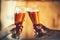 Two friends toasting with glasses of light beer at the pub