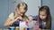 Two friends together paint a piggy bank. Good time together