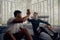 Two friends training in the gym - one with a prosthesis . Two men high fiving in the gym after a good training session