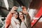 Two friends waiting going down stairs at the station before catching a train. Taking selfie with mobile phone. Travel photography