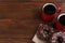 Two frosted donuts with sprinkles and cups of coffee on table, space for text