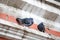 two frozen tousled gray pigeons are sitting on a building in the city