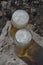 Two full glass glasses with beer on top of the stone outside