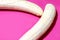 Two fully peeled bananas on a bright pink background top view close-up. Flat lay with copy space for text