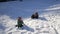 Two funny boys playing with a sled