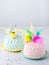 Two Funny cakes pink and pink with easter topper for kids with easter decorations on light background with space fot text. Easy