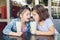 Two funny Caucasian little preschool sisters siblings drink milk shakes in cafe