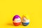 Two funny eggs boy and girl with faces on a yellow background - Easter, spring. Children`s toys-a symbol of a couple of men and