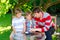 Two funny handsome kid boys and young father playing together checkers game. Sons, siblings children and dad spending