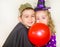 Two funny kids wearing witch and vampire costume on halloween