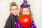 Two funny kids wearing witch and vampire costume on halloween