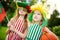 Two funny little sisters supporting and cheering their national basketball team during basketball championship