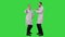 Two funny medical doctors with funny energy dance on a Green Screen, Chroma Key.