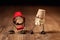 Two funny popcorn figures are doing a walk, wearing buckets as caps