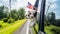 Two funny puppies watching from a car window, in a framed hand with an American flag