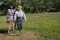 Two funny scarecrows in the field. Pair of scarecrows with hat and stick. Harvest protection and security concept. Rural landscape