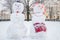 Two funny snow figures - a snowman and a woman