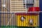 Two funny white and gray tame curious mouses hamsters with shiny eyes looking from bright yellow cage behind metal bars. Keeping