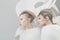 Two futuristic blonde women in white outfit over w